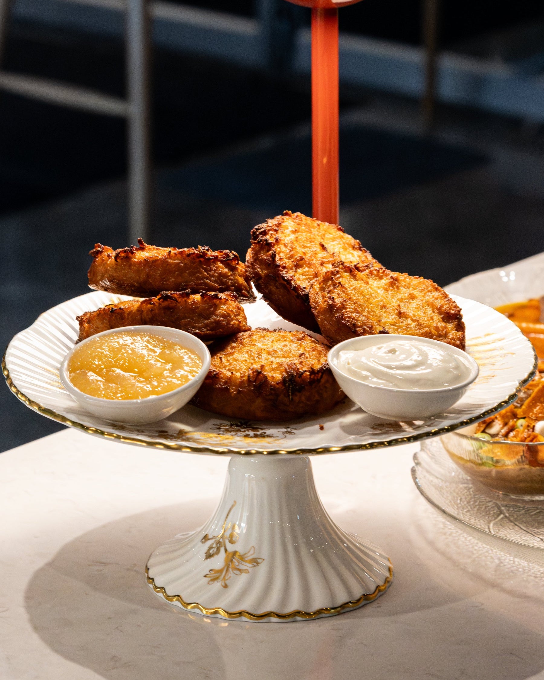 6 latkah  with apple sauce and quark on a platter
